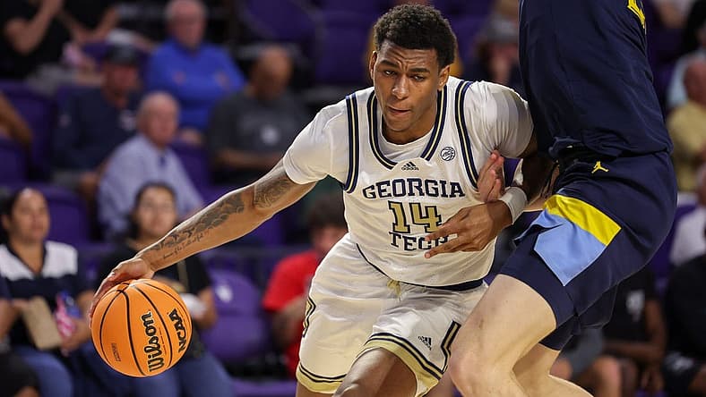 Nov 23, 2022; Fort Myers, Florida, USA; Georgia Tech Yellow Jackets forward Jalon Moore (14) drives past Marquette Golden Eagles forward Ben Gold (21) in the second half during the Fort Myers Tip-Off Beach Division third place game at Suncoast Credit Union Arena. Mandatory Credit: Nathan Ray Seebeck-USA TODAY Sports