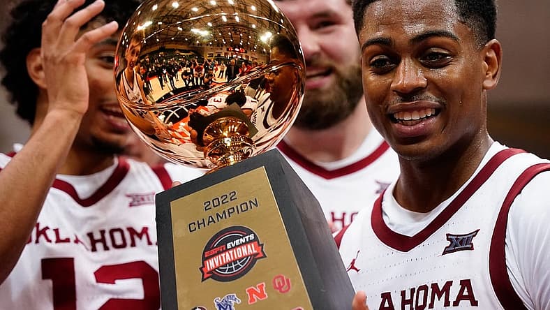 Nov 27, 2022; Orlando, FL, USA; Oklahoma Sooners guard Grant Sherfield (25) holds the ESPN Invitational Trophy after defeating the Mississippi Rebels at ESPN Wide World of Sports. Mandatory Credit: Rich Storry-USA TODAY Sports