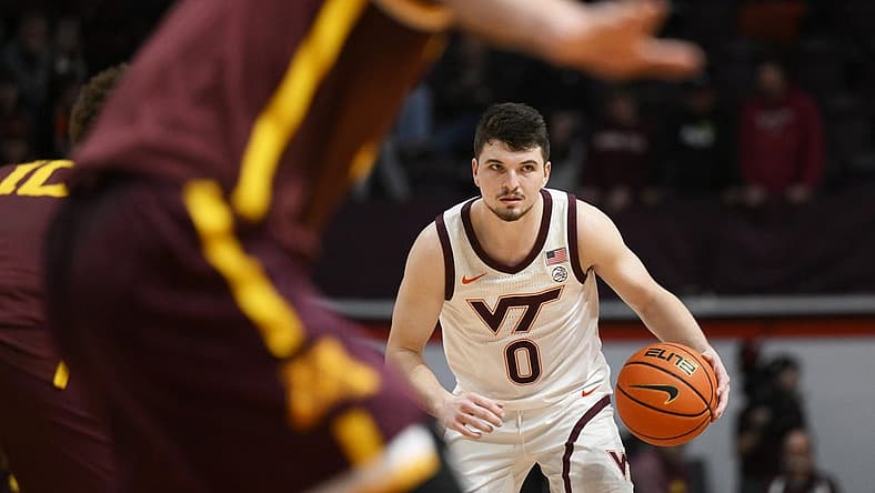 Nov 28, 2022; Blacksburg, Virginia, USA; Virginia Tech Hokies guard Hunter Cattoor (0) dribbles against the Minnesota Golden Gophers defense in the second half at Cassell Coliseum. Mandatory Credit: Lee Luther Jr.-USA TODAY Sports