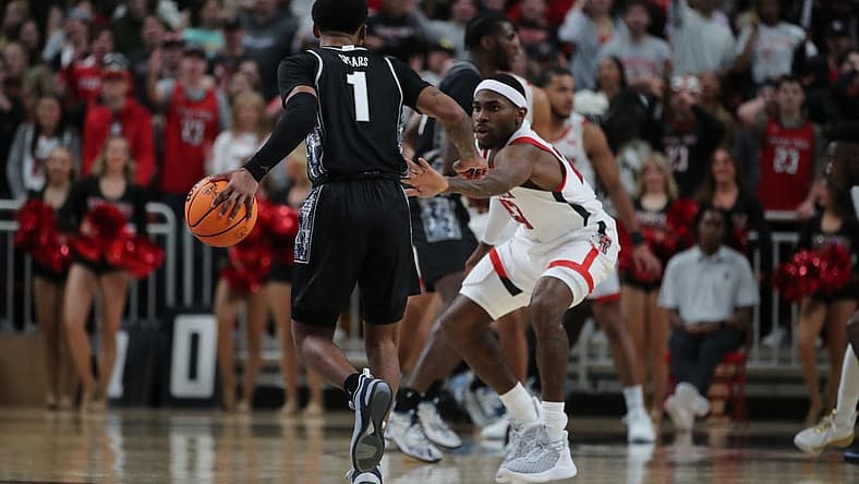 Nov 30, 2022; Lubbock, Texas, USA; Georgetown Hoyas guard Primo Spears (1) works the ball against Texas Tech Red Raiders guard De Vion Harmon (23) in the second half at United Supermarkets Arena. Mandatory Credit: Michael C. Johnson-USA TODAY Sports