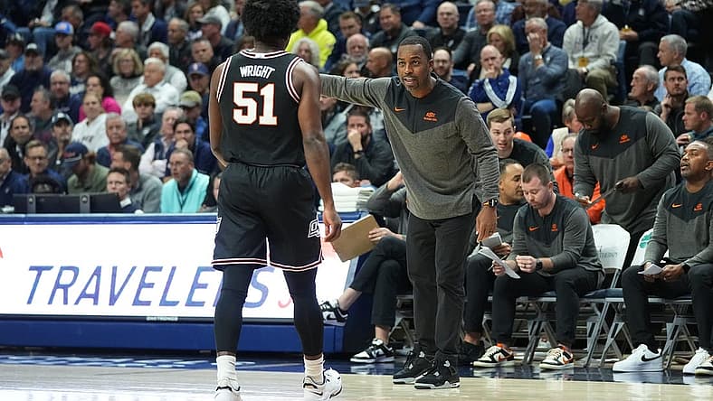 Dec 1, 2022; Storrs, Connecticut, USA; Oklahoma State Cowboys head coach Mike Boynton Jr. speaks with guard John-Michael Wright (51) during the first half against the Connecticut Huskies at Harry A. Gampel Pavilion. Mandatory Credit: Gregory Fisher-USA TODAY Sports