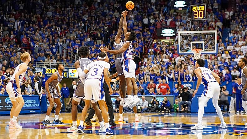 Dec 1, 2022; Lawrence, Kansas, USA; Seton Hall Pirates forward Tyrese Samuel (4) and Kansas Jayhawks forward K.J. Adams Jr. (24) battle for the opening jump ball during the first half at Allen Fieldhouse. Mandatory Credit: Denny Medley-USA TODAY Sports