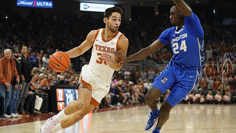 Dec 1, 2022; Austin, Texas, USA; Texas Longhorns forward Brock Cunningham (30) drives to the basket against Creighton Bluejays forward Arthur Kaluma (24) during the first half at Moody Center. Mandatory Credit: Scott Wachter-USA TODAY Sports