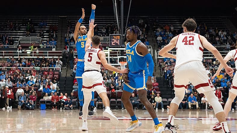 Dec 1, 2022; Stanford, California, USA; UCLA Bruins guard Amari Bailey (5) shoots the ball over Stanford Cardinal guard Michael O'Connell (5) during the first half at Maples Pavilion. Mandatory Credit: Stan Szeto-USA TODAY Sports