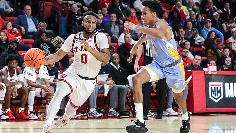 Nov 29, 2022; Queens, New York, USA;  St. John's Red Storm guard Posh Alexander (0) and Long Island University Sharks guard Jacob Johnson (4) at Carnesecca Arena. Mandatory Credit: Wendell Cruz-USA TODAY Sports