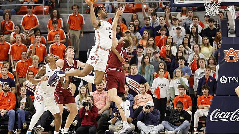 Dec 2, 2022; Auburn, Alabama, USA; Auburn Tigers forward Yohan Traore (21) takes a shot over Colgate Raiders forward Ryan Moffatt (4) during the first half at Neville Arena. Mandatory Credit: John Reed-USA TODAY Sports
