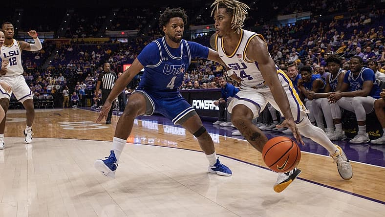 Dec 2, 2022; Baton Rouge, Louisiana, USA;  LSU Tigers guard Adam Miller (44) dribbles against Texas-Arlington Mavericks guard Kyron Gibson (4) during the first half at Pete Maravich Assembly Center. Mandatory Credit: Stephen Lew-USA TODAY Sports