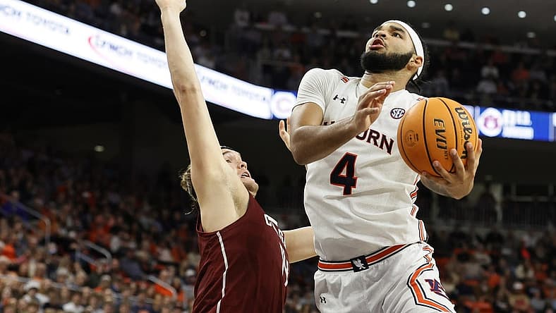 Dec 2, 2022; Auburn, Alabama, USA; Auburn Tigers forward Johni Broome (4) gets past Colgate Raiders forward Keegan Records (14) for a shot during the second half at Neville Arena. Mandatory Credit: John Reed-USA TODAY Sports