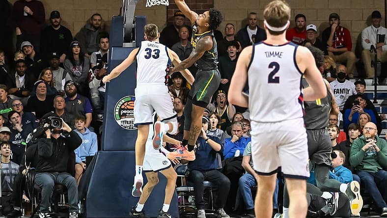 Dec 2, 2022; Sioux Falls, South Dakota, USA;  Baylor Bears guard Langston Love (13) dunks on Gonzaga Bulldogs forward Ben Gregg (33) in the first half at Sanford Pentagon. Mandatory Credit: Steven Branscombe-USA TODAY Sports
