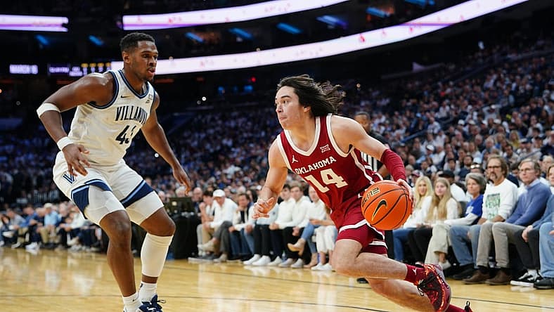 Dec 3, 2022; Philadelphia, Pennsylvania, USA; Oklahoma Sooners guard Bijan Cortes (14) dribbles the ball against Villanova Wildcats forward Eric Dixon (43) during the first half at Wells Fargo Center. Mandatory Credit: Gregory Fisher-USA TODAY Sports
