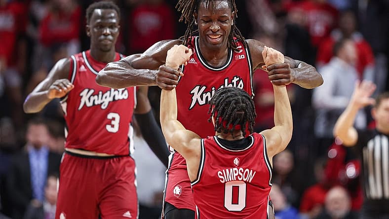 Dec 3, 2022; Piscataway, New Jersey, USA; Rutgers Scarlet Knights center Clifford Omoruyi (11) helps guard Derek Simpson (0) up after being fouled by Rutgers Scarlet Knights forward Mawot Mag (3) during the second half against the Indiana Hoosiers at Jersey Mike's Arena. Mandatory Credit: Vincent Carchietta-USA TODAY Sports