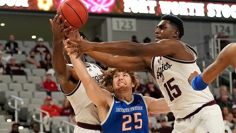 Dec 3, 2022; Fort Worth, Texas, USA; Boise State Broncos center Lukas Milner (25) fights for a loose ball against Texas A&M Aggies forward Julius Marble (34) and forward Henry Coleman III (15) during the first half at Dickies Arena. Mandatory Credit: Chris Jones-USA TODAY Sports