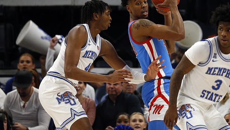 Dec 3, 2022; Memphis, Tennessee, USA; Memphis Tigers forward Chandler Lawson (4) defends Mississippi Rebels forward Robert Allen (21) during the first half at FedExForum. Mandatory Credit: Petre Thomas-USA TODAY Sports