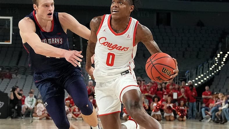 Dec 3, 2022; Fort Worth, Texas, USA; Houston Cougars guard Marcus Sasser (0) drives to the basket past St. Mary's Gaels center Mitchell Saxen (11) during the first half at Dickies Arena. Mandatory Credit: Chris Jones-USA TODAY Sports