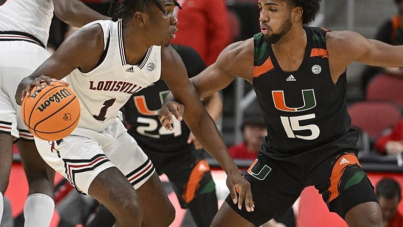 Dec 4, 2022; Louisville, Kentucky, USA; Louisville Cardinals guard Mike James (1) dribble against Miami (Fl) Hurricanes forward Norchad Omier (15) during the first half at KFC Yum! Center. Mandatory Credit: Jamie Rhodes-USA TODAY Sports