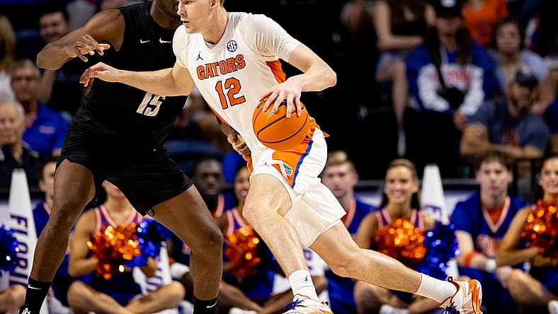 Dec 4, 2022; Gainesville, Florida, USA; Florida Gators forward Colin Castleton (12) drives to the basket against Stetson Hatters forward Mahamadou Diawara (15) during the first half at Exactech Arena at the Stephen C. O'Connell Center. Mandatory Credit: Matt Pendleton-USA TODAY Sports