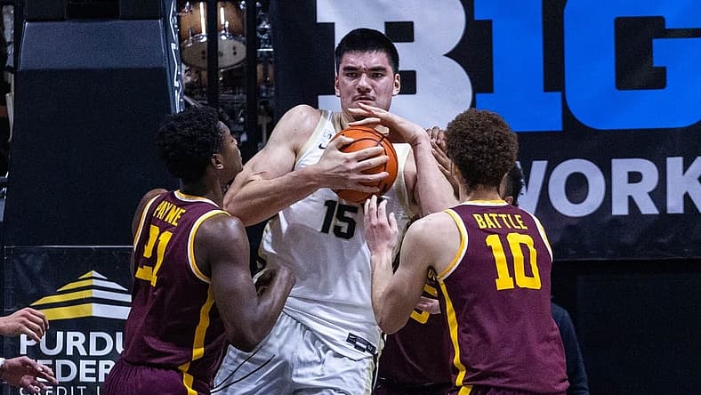 Dec 4, 2022; West Lafayette, Indiana, USA; Purdue Boilermakers center Zach Edey (15) rebounds the ball while Minnesota Golden Gophers forward Jamison Battle (10) and guard Jackson Purcell (11) defend in the first half at Mackey Arena. Mandatory Credit: Trevor Ruszkowski-USA TODAY Sports