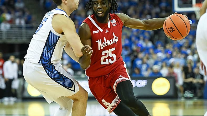 Dec 4, 2022; Omaha, Nebraska, USA; Nebraska Cornhuskers guard Emmanuel Bandoumel (25) drives against Creighton Bluejays guard Francisco Farabello (5) in the first half at CHI Health Center Omaha. Mandatory Credit: Steven Branscombe-USA TODAY Sports