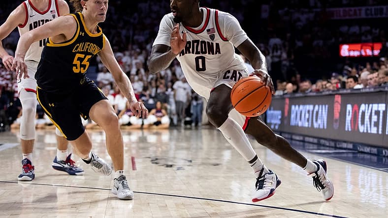 Dec 4, 2022; Tucson, Arizona, USA; Arizona Wildcats guard Courtney Ramey (0) drives to the basket against California Golden Bears guard Devin Askew (55) during the second half at McKale Center. Mandatory Credit: Zachary BonDurant-USA TODAY Sports
