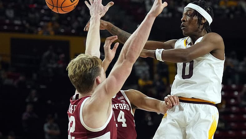 Dec 4, 2022; Tempe, Arizona, USA; Arizona State Sun Devils guard DJ Horne (0) passes the ball by Stanford Cardinal defenders during the second half at Desert Financial Arena. Mandatory Credit: Joe Camporeale-USA TODAY Sports