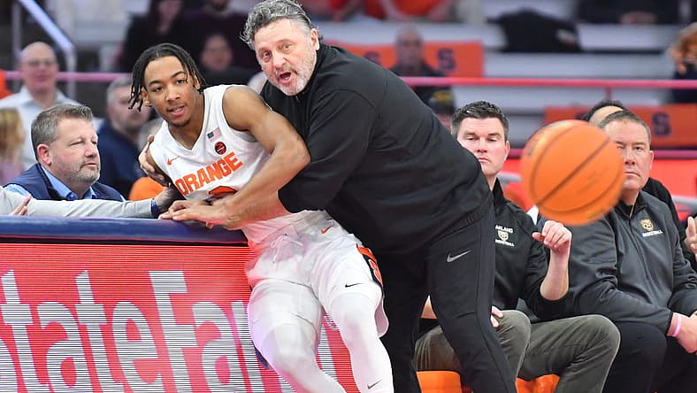 Dec 6, 2022; Syracuse, New York, USA; Syracuse Orange guard Judah Mintz (3) is caught by Oakland Golden Grizzlies head coach Greg Kampe after going off court for a loose ball in the first half at JMA Wireless Dome. Mandatory Credit: Mark Konezny-USA TODAY Sports