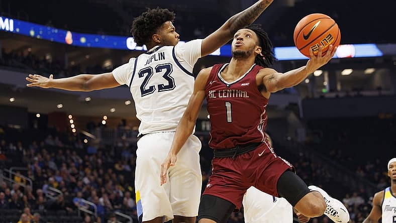 Dec 6, 2022; Milwaukee, Wisconsin, USA; North Carolina Central Eagles guard Ja'darius Harris (1) shoots around Marquette Golden Eagles forward David Joplin (23) during the first half at Fiserv Forum. Mandatory Credit: Jeff Hanisch-USA TODAY Sports