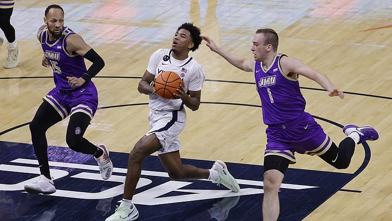 Dec 6, 2022; Charlottesville, Virginia, USA; Virginia Cavaliers guard Reece Beekman (2) drives to the basket as James Madison Dukes guard Takal Molson (15) and Dukes guard Noah Freidel (1) defend in the first half at John Paul Jones Arena. Mandatory Credit: Geoff Burke-USA TODAY Sports
