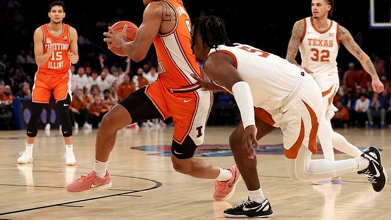 Dec 6, 2022; New York, New York, USA; Illinois Fighting Illini guard Terrence Shannon Jr. (0) drives to the basket against Texas Longhorns guard Marcus Carr (5) during the second half at Madison Square Garden. Mandatory Credit: Brad Penner-USA TODAY Sports