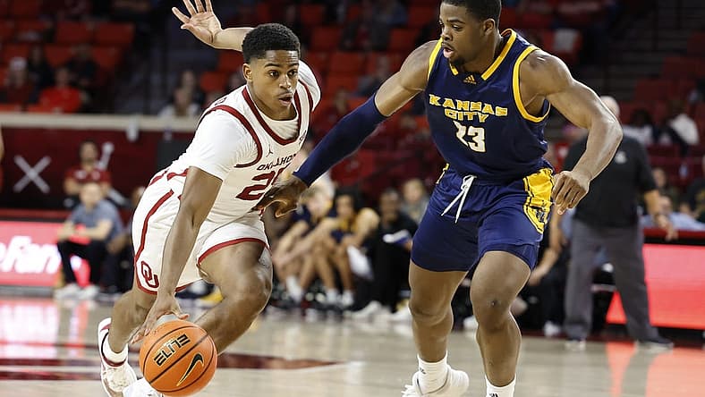 Dec 6, 2022; Norman, Oklahoma, USA; Oklahoma Sooners guard Grant Sherfield (25) drives to the basket against Kansas City Roos forward Allen David Mukeba Jr. (23) during the second half at Lloyd Noble Center. Oklahoma won 75-53. Mandatory Credit: Alonzo Adams-USA TODAY Sports