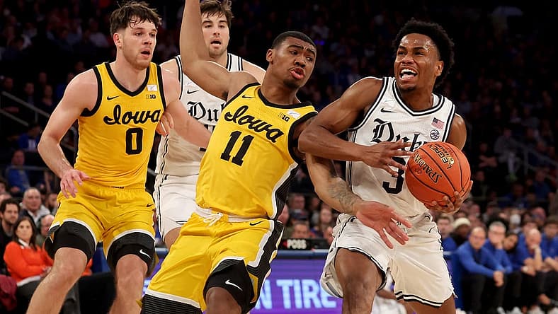 Dec 6, 2022; New York, New York, USA; Duke Blue Devils guard Jeremy Roach (3) is fouled by Iowa Hawkeyes guard Tony Perkins (11) as he drives to the basket during the first half at Madison Square Garden. Mandatory Credit: Brad Penner-USA TODAY Sports