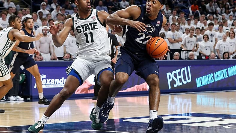 Dec 7, 2022; University Park, Pennsylvania, USA; Penn State Nittany Lions guard Jalen Pickett (22) drives the ball towards the basket as Michigan State Spartans guard AJ Hoggard (11) defends during the first half at Bryce Jordan Center. Mandatory Credit: Matthew OHaren-USA TODAY Sports