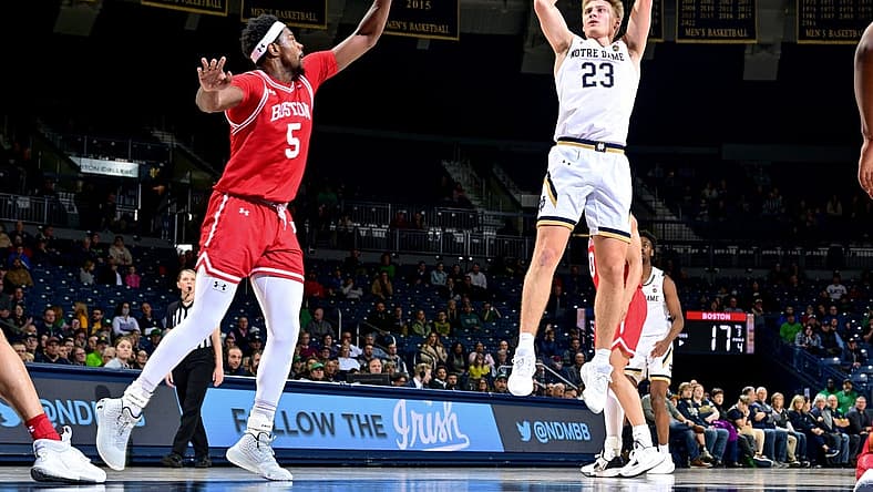 Dec 7, 2022; South Bend, Indiana, USA; Notre Dame Fighting Irish guard Dane Goodwin (23) shoots over Boston University Terriers guard Walter Whyte (5) in the first half at the Purcell Pavilion. Mandatory Credit: Matt Cashore-USA TODAY Sports