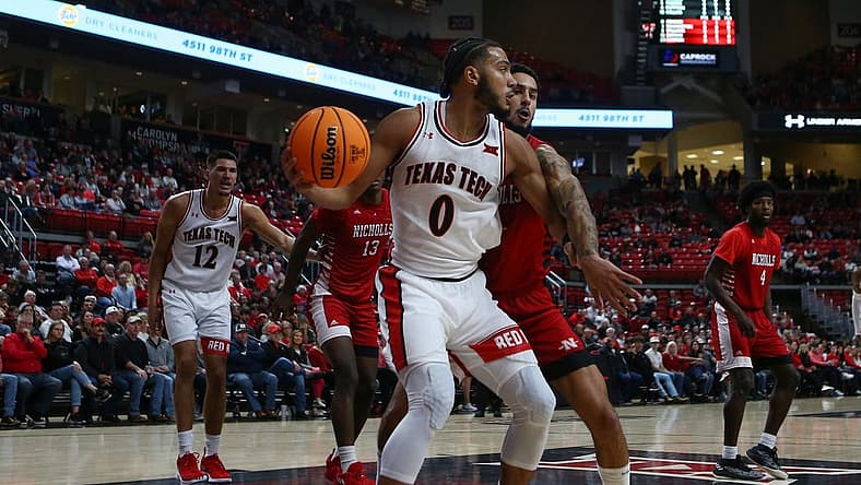 Dec 7, 2022; Lubbock, Texas, USA; Texas Tech Red Raiders forward Kevin Obanor (0) works the ball against Nicholls Colonels forward Marek Nelson (0) in the first half at United Supermarkets Arena. Mandatory Credit: Michael C. Johnson-USA TODAY Sports