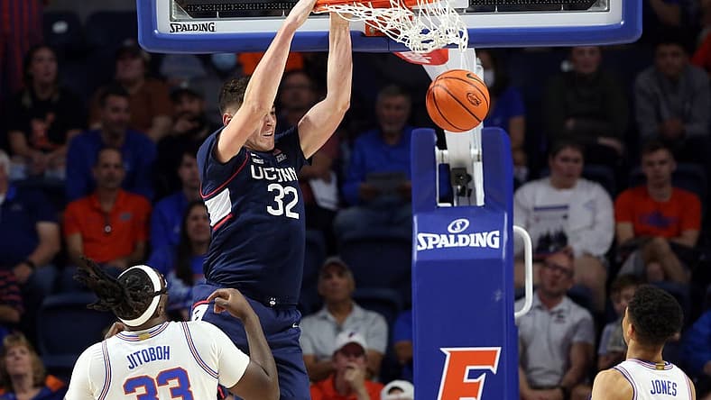 Dec 7, 2022; Gainesville, Florida, USA; Connecticut Huskies center Donovan Clingan (32) dunks against the Florida Gators during the first half at Exactech Arena at the Stephen C. O'Connell Center. Mandatory Credit: Kim Klement-USA TODAY Sports