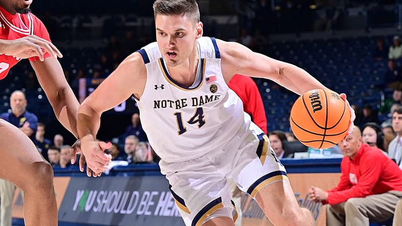 Dec 7, 2022; South Bend, Indiana, USA; Notre Dame Fighting Irish forward Nate Laszewski (14) drives to the basket as Boston University Terriers forward Malcolm Chimezie (3) defends in the first half at the Purcell Pavilion. Mandatory Credit: Matt Cashore-USA TODAY Sports