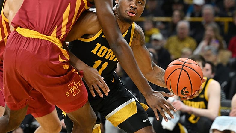 Dec 8, 2022; Iowa City, Iowa, USA; Iowa Hawkeyes guard Tony Perkins (11) controls the ball as Iowa State Cyclones forward Hason Ward (24) defends during the first half at Carver-Hawkeye Arena. Mandatory Credit: Jeffrey Becker-USA TODAY Sports