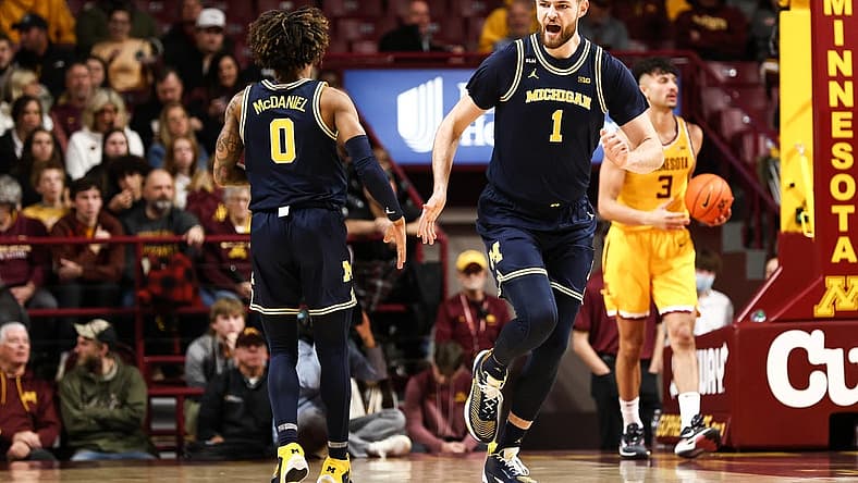 Dec 8, 2022; Minneapolis, Minnesota, USA; Michigan Wolverines center Hunter Dickinson (1) reacts to his shot against the Minnesota Golden Gophers during the first half at Williams Arena. Mandatory Credit: Matt Krohn-USA TODAY Sports