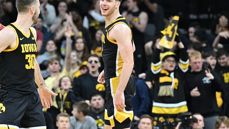 Dec 8, 2022; Iowa City, Iowa, USA; Iowa Hawkeyes forward Filip Rebraca (0) reacts with guard Connor McCaffery (30) during the second half against the Iowa State Cyclones at Carver-Hawkeye Arena. Mandatory Credit: Jeffrey Becker-USA TODAY Sports