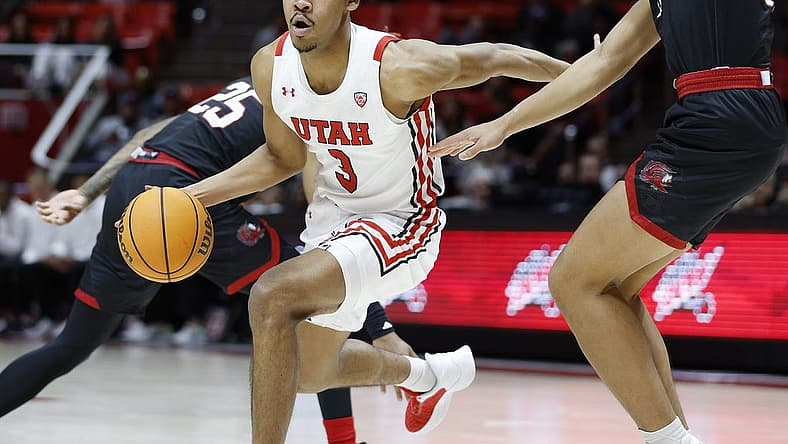 Dec 8, 2022; Salt Lake City, Utah, USA; Utah Utes forward Bostyn Holt (3) drives past Jacksonville State Gamecocks guard Travis Roberts (11) in the second half at Jon M. Huntsman Center. Mandatory Credit: Jeffrey Swinger-USA TODAY Sports