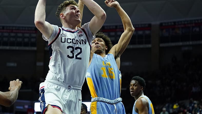 Dec 10, 2022; Storrs, Connecticut, USA; UConn Huskies center Donovan Clingan (32) shoots against Long Island Sharks forward/center C.J. Delancy (15) in the first half at Harry A. Gampel Pavilion. Mandatory Credit: David Butler II-USA TODAY Sports