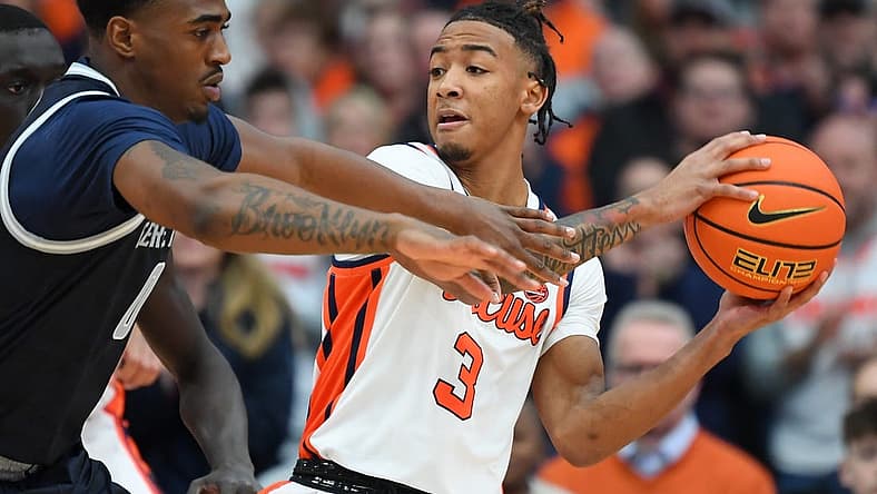 Dec 10, 2022; Syracuse, New York, USA; Syracuse Orange guard Judah Mintz (3) controls the ball as Georgetown Hoyas guard Brandon Murray (0) defends during the first half at the JMA Wireless Dome. Mandatory Credit: Rich Barnes-USA TODAY Sports