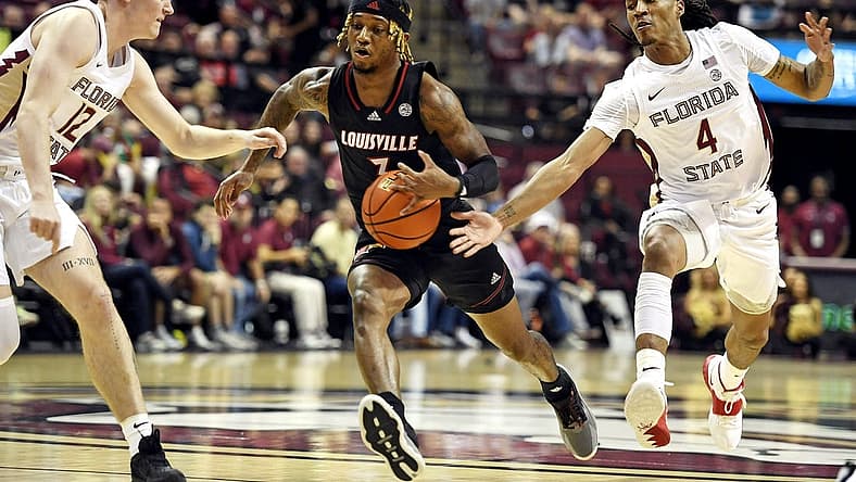 Dec 10, 2022; Tallahassee, Florida, USA; Louisville Cardinals El Ellis (3) has the ball tipped away by Florida State Seminoles guard Caleb Mills (4) during the first half at Donald L. Tucker Center. Mandatory Credit: Melina Myers-USA TODAY Sports