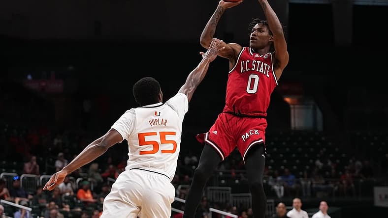 Dec 10, 2022; Coral Gables, Florida, USA; North Carolina State Wolfpack guard Terquavion Smith (0) shoots over Miami Hurricanes guard Wooga Poplar (55) during the first half at Watsco Center. Mandatory Credit: Jasen Vinlove-USA TODAY Sports