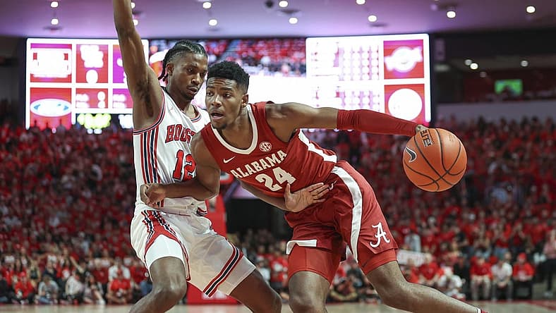 Dec 10, 2022; Houston, Texas, USA; Alabama Crimson Tide forward Brandon Miller (24) drives with the ball as Houston Cougars guard Tramon Mark (12) defends during the first half at Fertitta Center. Mandatory Credit: Troy Taormina-USA TODAY Sports