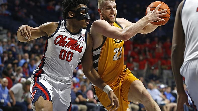 Dec 10, 2022; Oxford, Mississippi, USA; Valparaiso Beacons forward Ben Krikke (23) drives to the basket as Mississippi Rebels forward Jayveous McKinnis (0) defends during the first half at The Sandy and John Black Pavilion at Ole Miss. Mandatory Credit: Petre Thomas-USA TODAY Sports