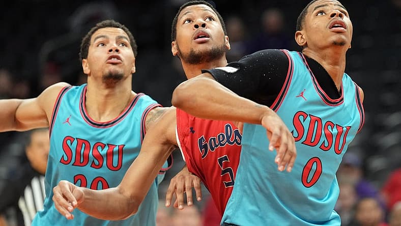 Dec 10, 2022; Phoenix, Arizona, USA; San Diego State Aztecs guard Matt Bradley (20) and San Diego State Aztecs forward Keshad Johnson (0) box out St. Mary's Gaels forward Josh Jefferson (5) during the first half at Footprint Center. Mandatory Credit: Joe Camporeale-USA TODAY Sports