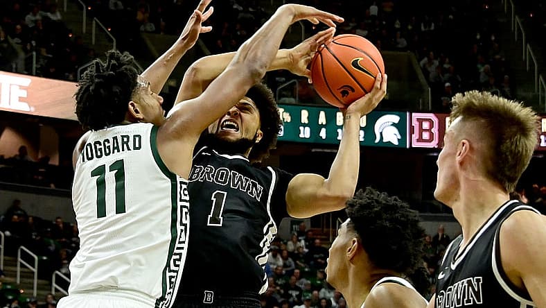Dec 10, 2022; East Lansing, Michigan, USA;  Michigan State Spartans guard A.J. Hoggard (11) stops Brown Bears guard Dan Friday (1) at Jack Breslin Student Events Center. Mandatory Credit: Dale Young-USA TODAY Sports