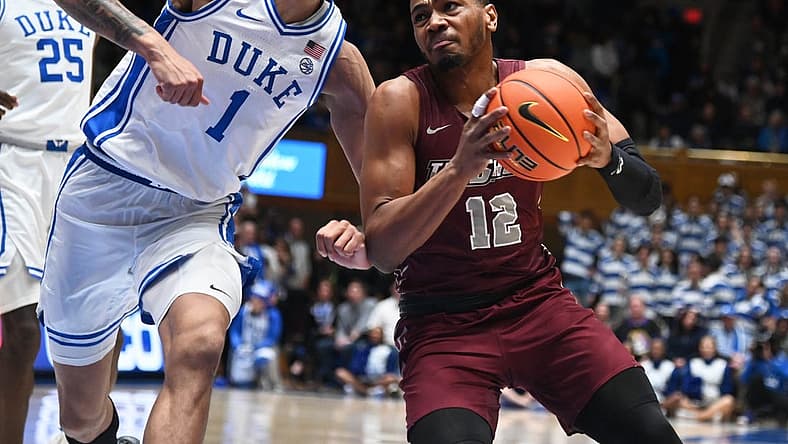 Dec 10, 2022; Durham, North Carolina, USA; Maryland Eastern Shore Eagles forward Nathaniel Pollard Jr. (12) drives to the basket as Duke Blue Devils center Dereck Lively (1) defends during the first half at Cameron Indoor Stadium. Mandatory Credit: Rob Kinnan-USA TODAY Sports