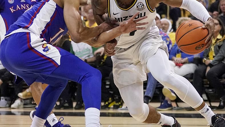 Dec 10, 2022; Columbia, Missouri, USA; Missouri Tigers guard DeAndre Gholston (4) dribbles the ball as Kansas Jayhawks guard Kevin McCullar Jr. (15) defends during the first half at Mizzou Arena. Mandatory Credit: Denny Medley-USA TODAY Sports