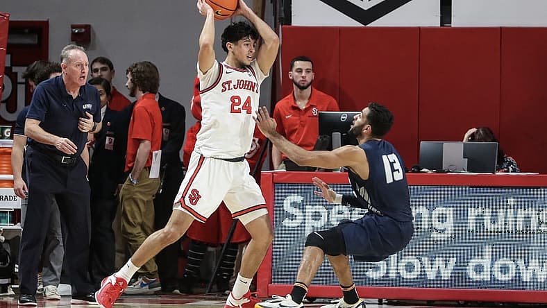 Dec 10, 2022; Queens, New York, USA; St. John's Red Storm guard Rafael Pinzon (24) looks to pass over New Hampshire Wildcats guard Matt Herasme (13) in the first half at Carnesecca Arena. Mandatory Credit: Wendell Cruz-USA TODAY Sports